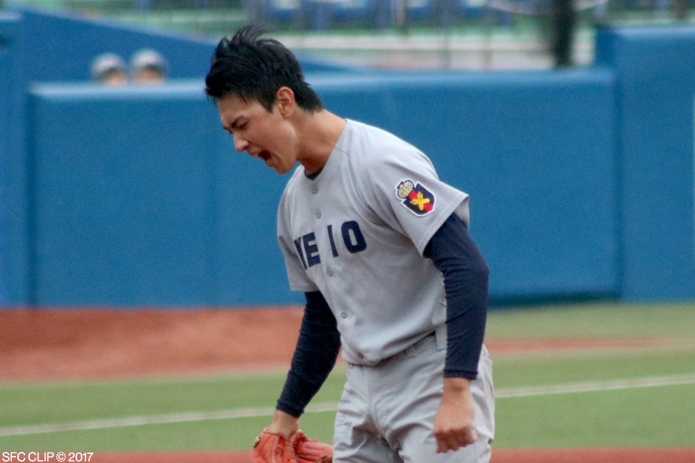 Keio's pitcher shouts in victory after successfully striking out Waseda's last batter in the ninth inning